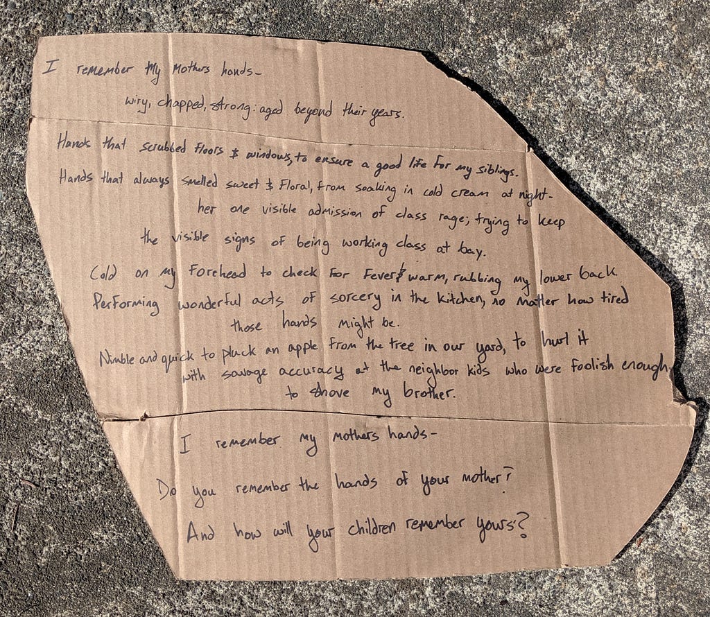 Photograph of the poem on a concrete background. Poem is also included below.