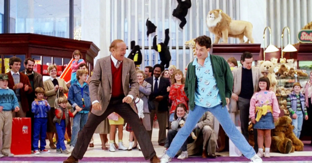 Iconic scene from the 1988 film, Big, directed by Penny Marshall. Pictured left, actor Robert Loggia. Pictured right, actor Tom Hanks. The cast of the toy store scene in the background, less diverse than the animal toy propped on set of the famous toy store, FAO Schwarz.