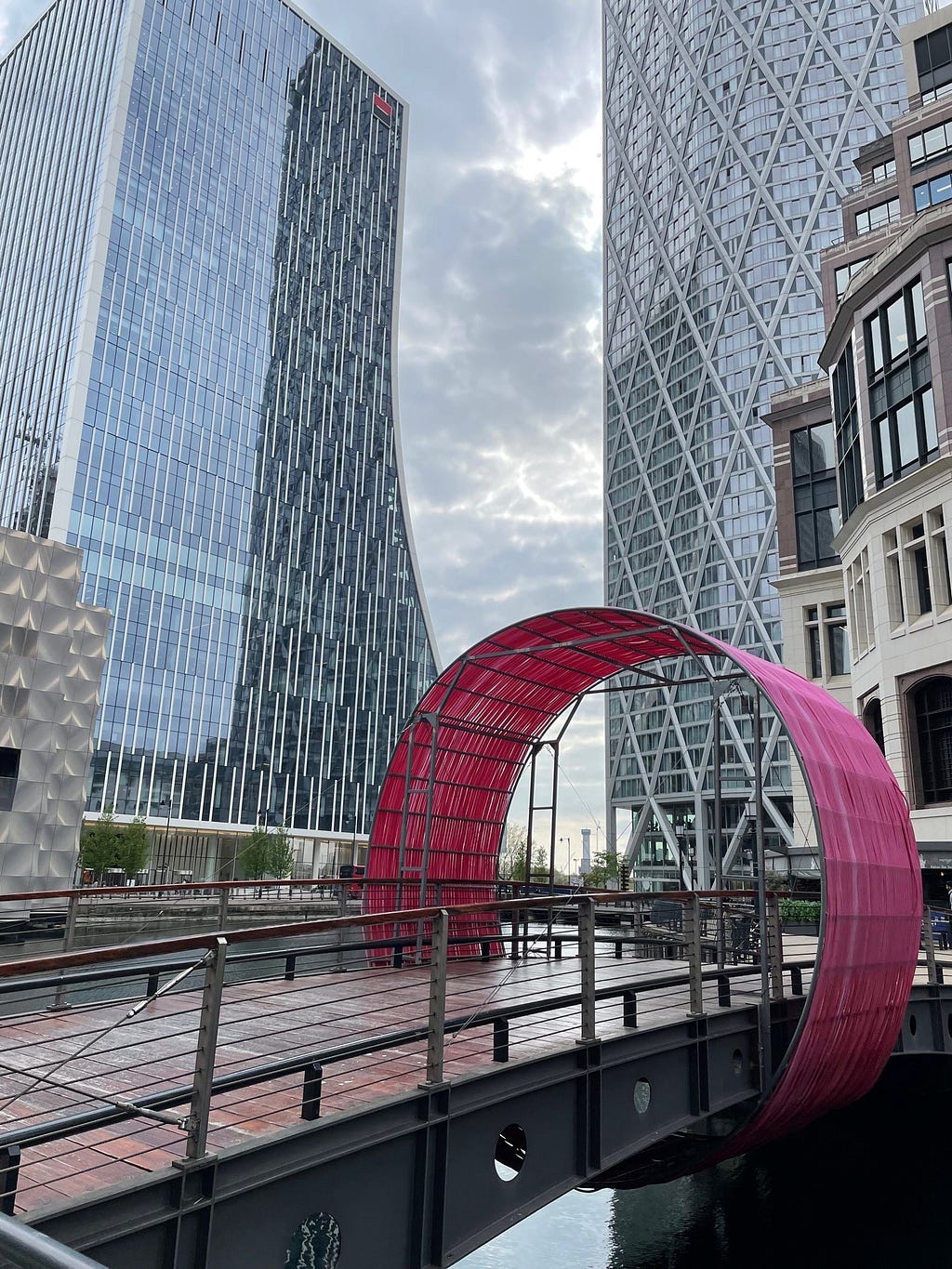 A circular sculpture over a bridge in Canary Wharf, London