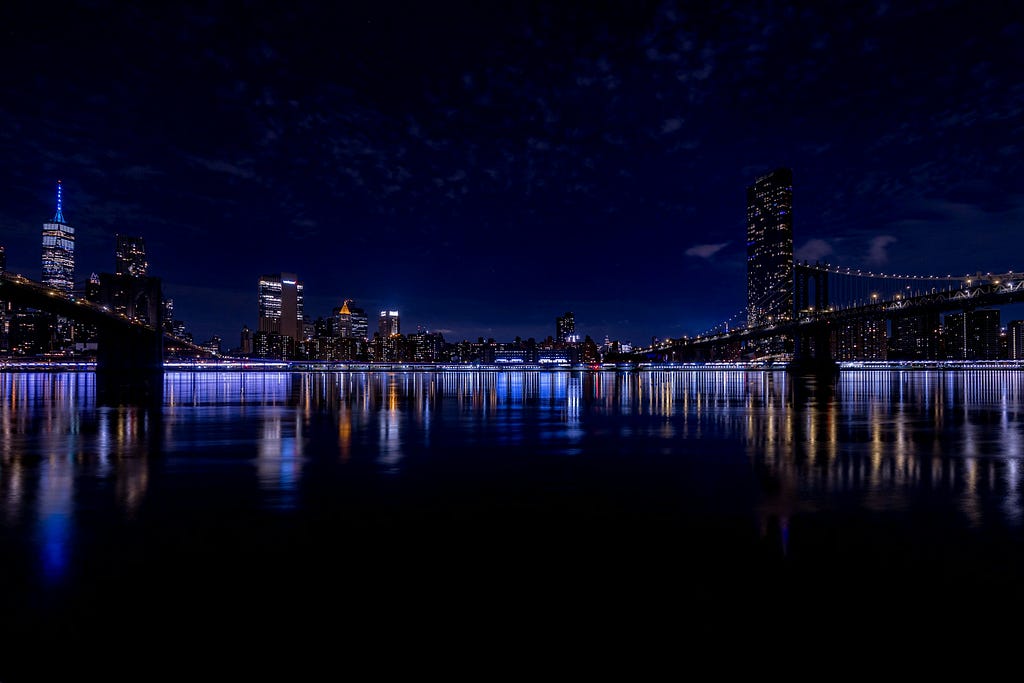 Lights of a city at night reflected across the water