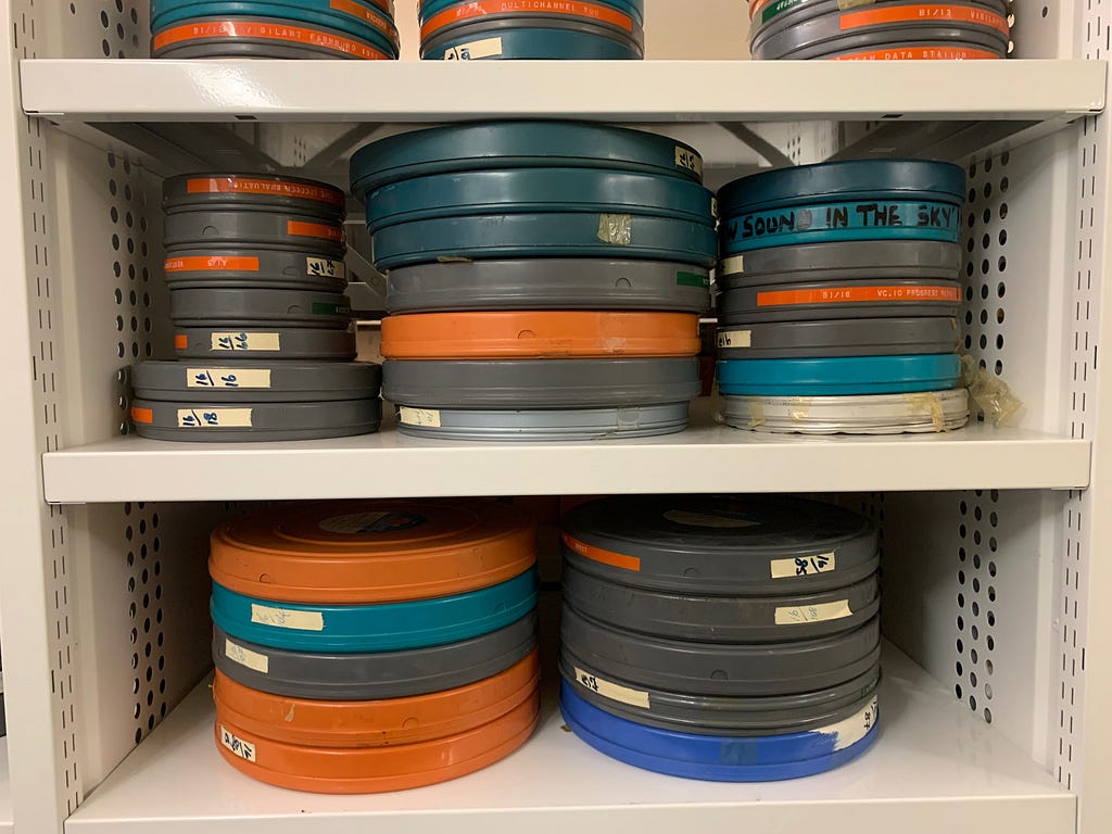 Shelves with piles of variously coloured film canisters.