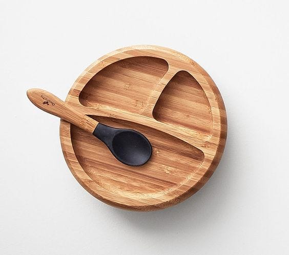 An elaborate plate and spoon made out of bamboo