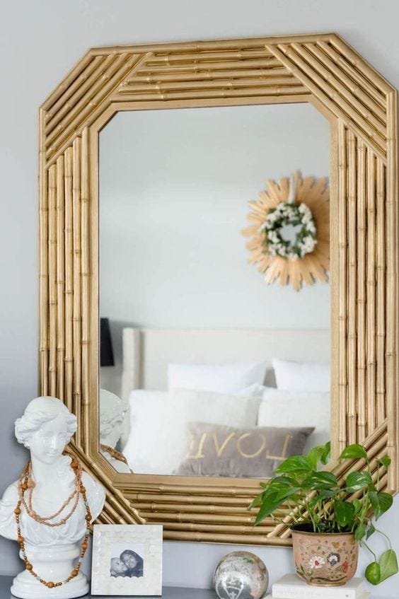 A beautiful mirror with a frame made out of bamboo