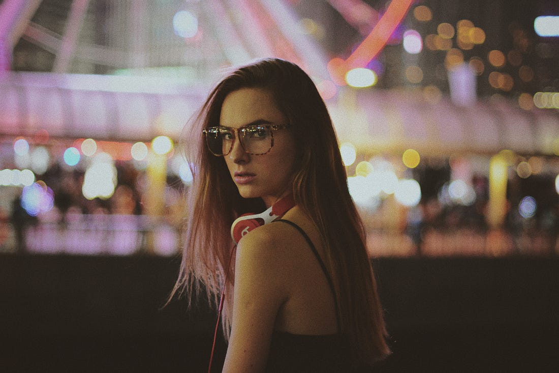 woman wearing glasses in an amusement park