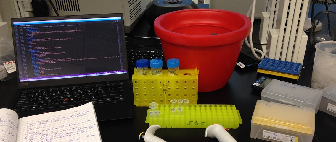 A biology lab desk with a laptop.