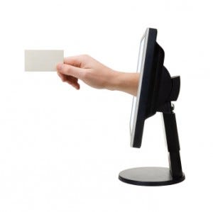 Computer screen and hand with card