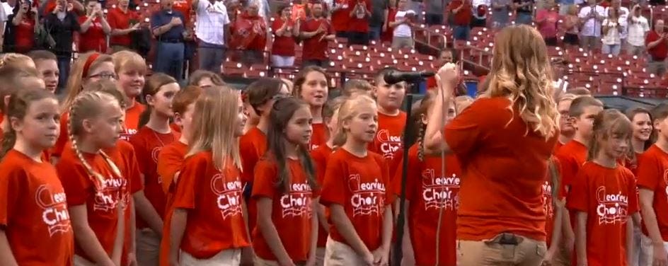 members of the St. Louis Cardinals stand for the National Anthem