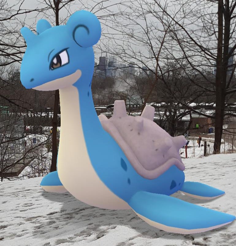 A cute little blue sea monster with flippers and a saddle on its back, sitting on the snow.