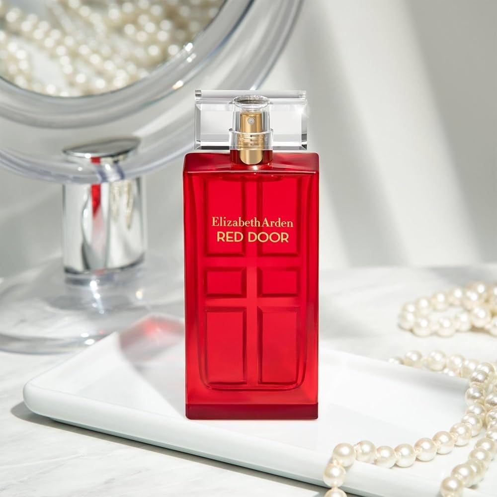 An Equisite Bottol of the Elizabeth Arden Red Door Perdfume on the Tray with Pearls on its side gives its Elegant Look