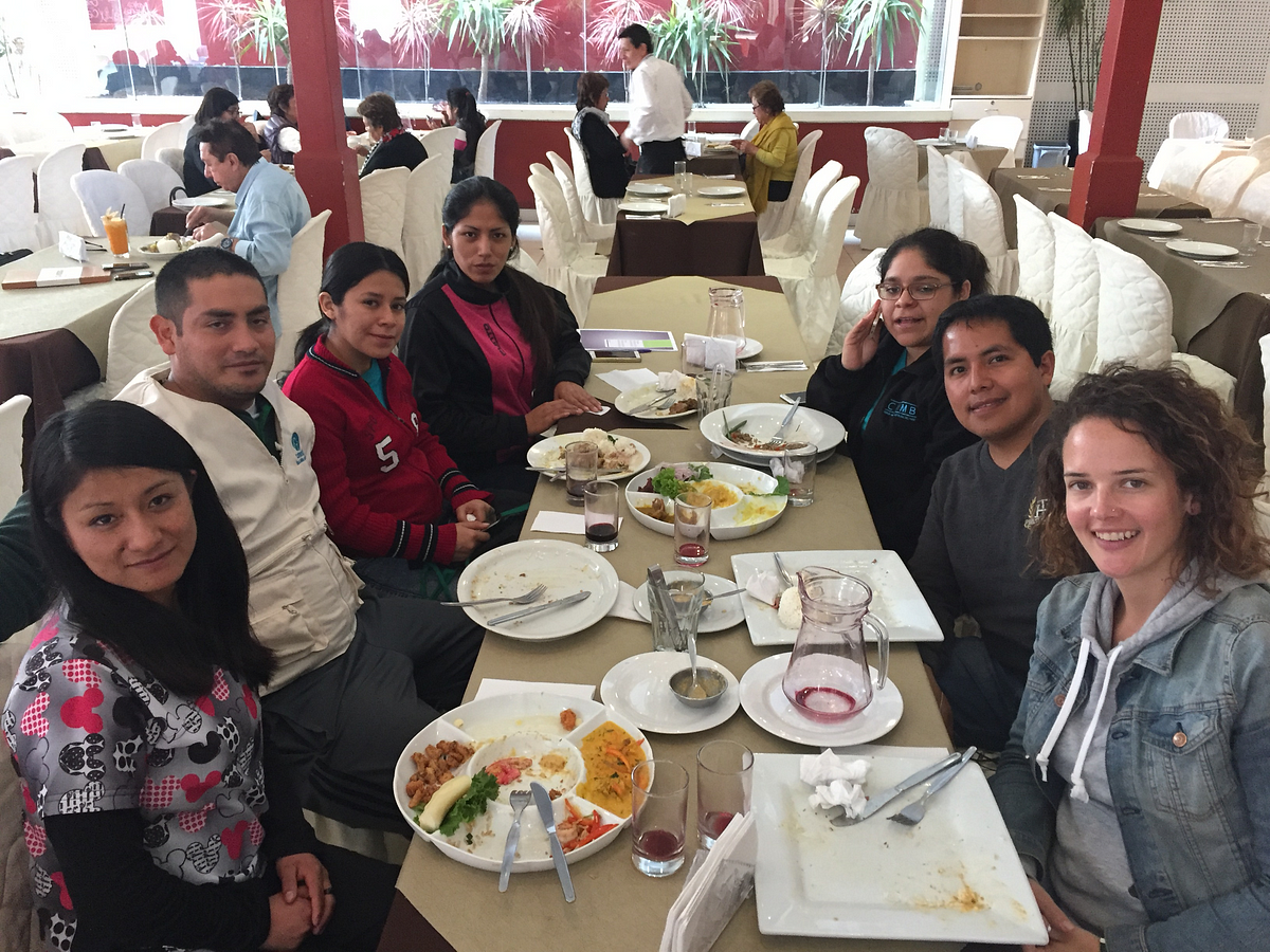 CMMB staff with international catholic volunteer Megan Ramirez sharing a Peruvian meal.