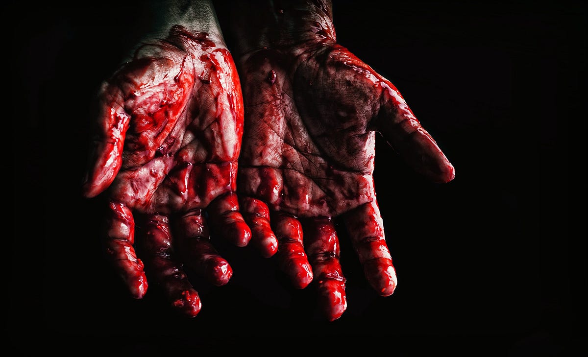 A pair of hands smeared with blood.