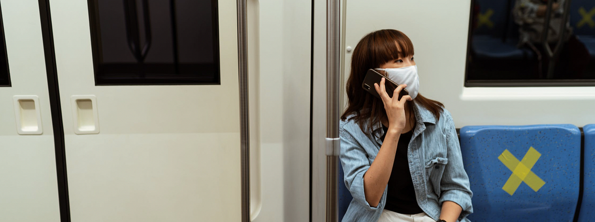 Woman wearing mask talking loud on her smart phone