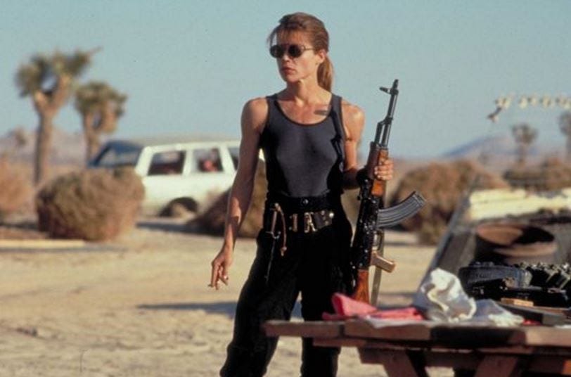 Sarah Conor standing in desert with gun from Terminator 2