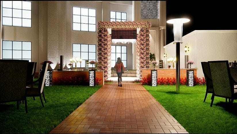 A beautifully lit entrance walkway of DP Palace in Delhi, adorned with floral arrangements and elegant decor. The lush green lawn, ambient lighting, and regal seating reflect the meticulous detailing by the Best Interior Designer in Delhi. This view highlights the finesse and ambiance crafted by a top Interior Designer in Delhi, where luxury meets functionality in every corner of the celebration space.