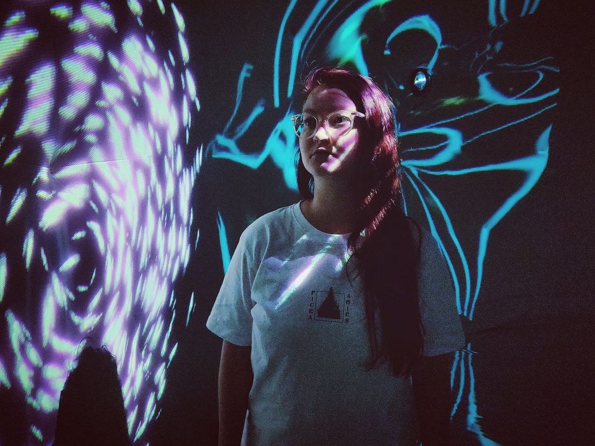 Woman standing in front of projection