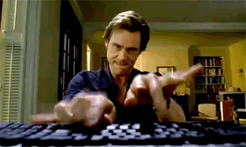 man typing furiously on keyboard