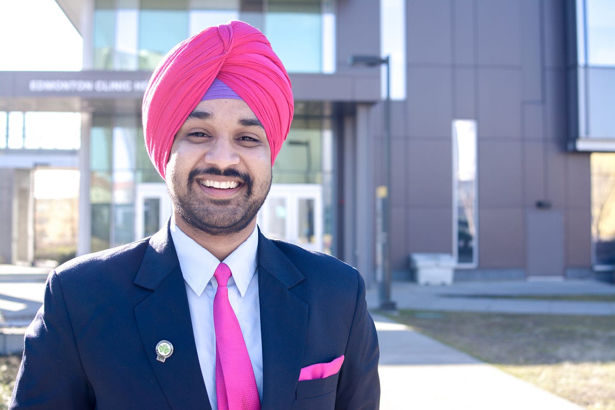 Smiling man in suit and bright turban