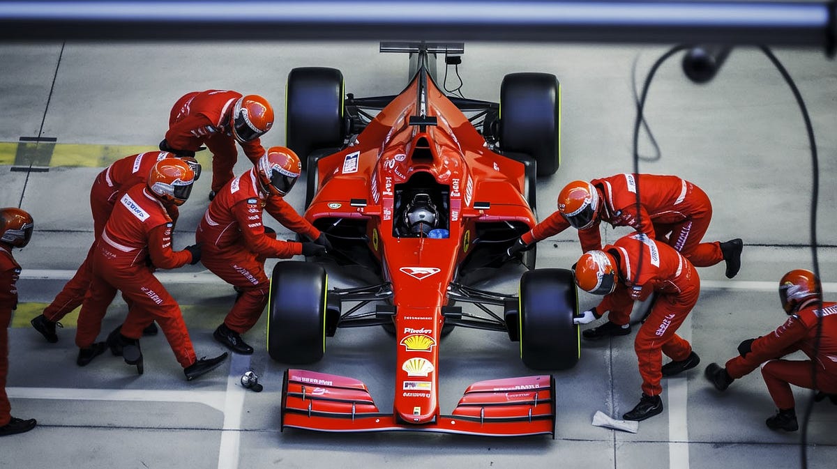 A photo of a Formula 1 team performing a pit stop.
