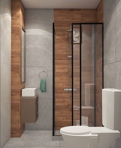 A modern compact bathroom with warm wood-textured panels, sleek grey tiles, glass shower partition, and floating vanity — designed by ArchitectsHive, the best interior designer in Gurugram. This smartly designed space highlights the precision of an interior designer in Gurugram and the detailing expertise of interior decorators in Gurugram, combining utility with contemporary elegance.