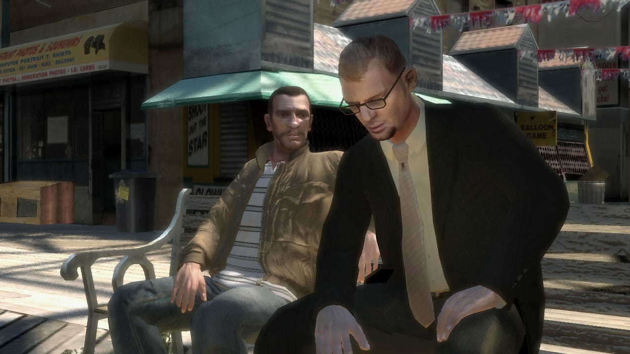 Screnshot of the game. Two men sit on a bench outside of a row of stores. A man in a suit and tie leans forward, concerned, while the other, in a tan jacket and jeans, leans back to listen.