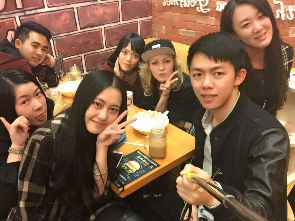 selfie of group of chinese people with foreigner