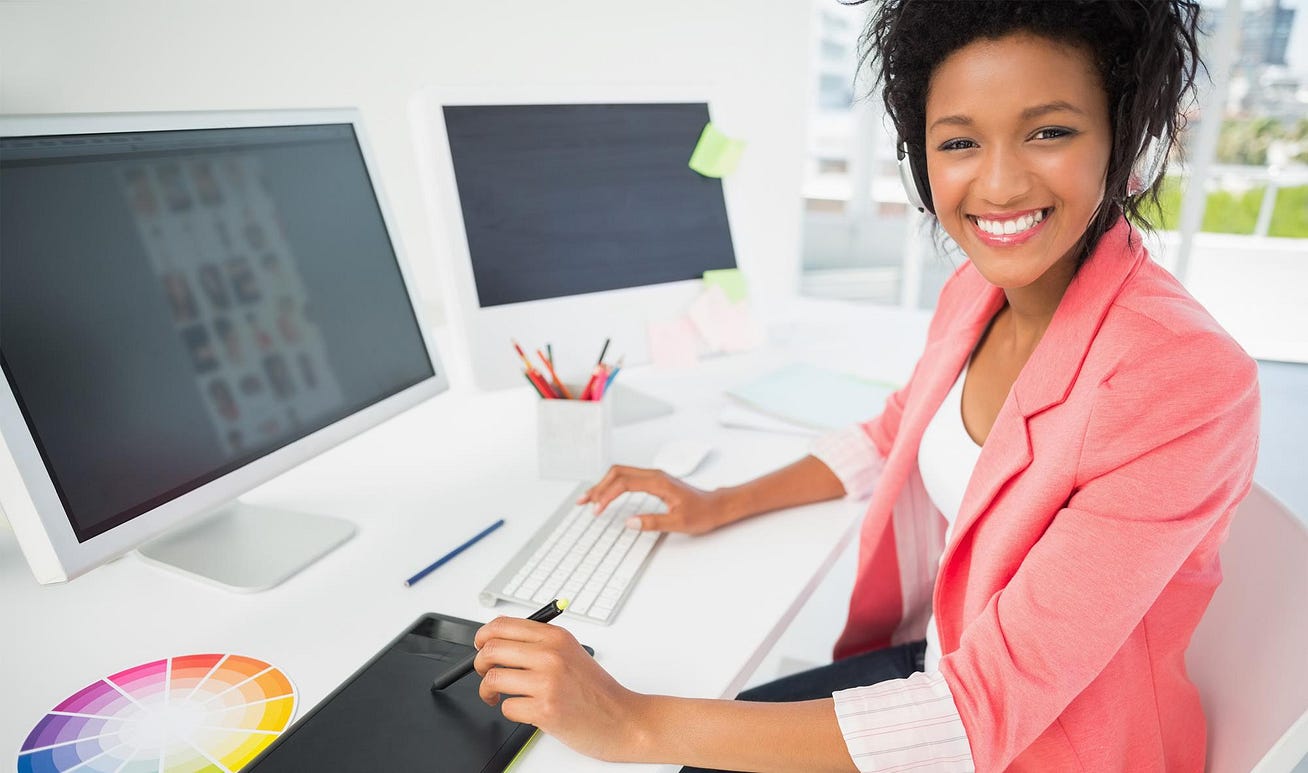 female graphic designer with headphones smiling