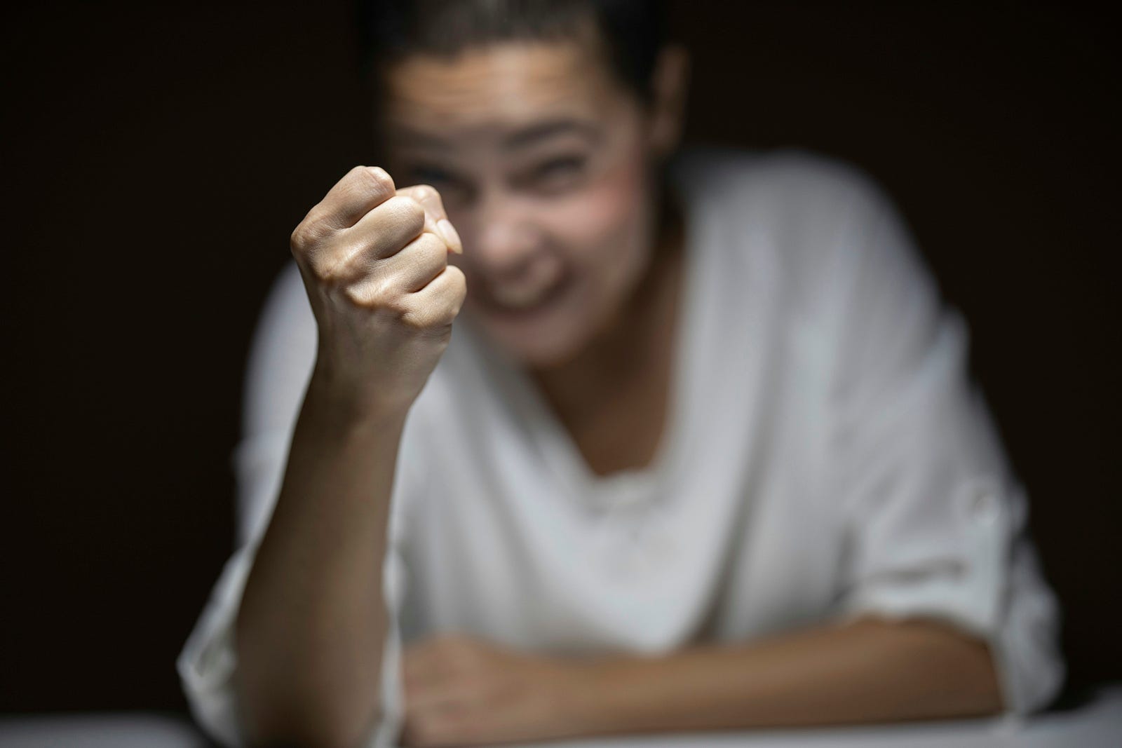 A person squeezes her fist in anger.