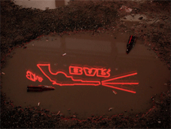 Roadhouse neon signage reflected in parking lot puddle animated GIF