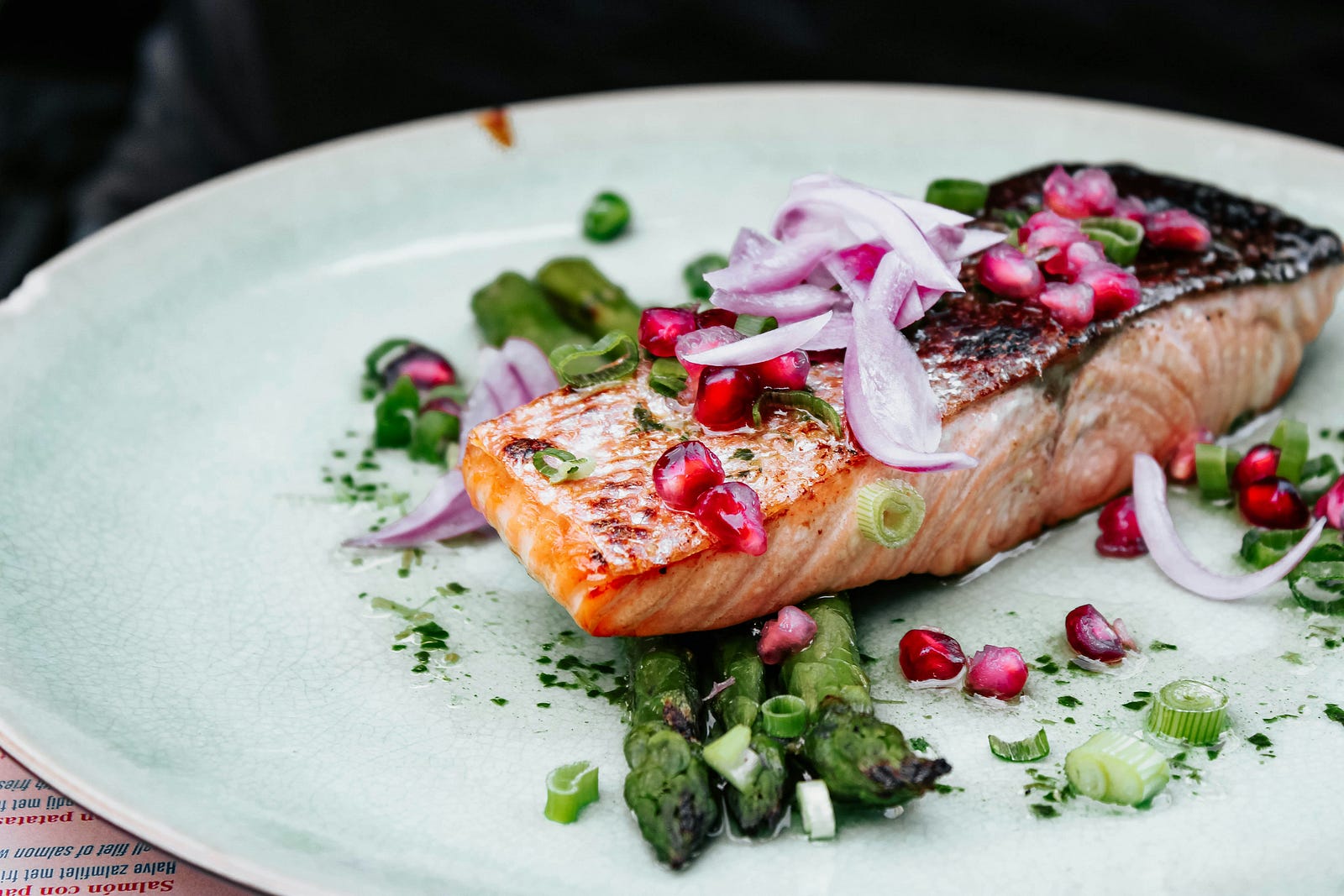 A pice of cooked salmon sits on a white plate, surrounded by vegetables. is your diet healthy? Are you incorporating lots of fruits, vegetables, and whole grains? What about lean proteins rich in antioxidants? For me, this means a Mediterranean diet.