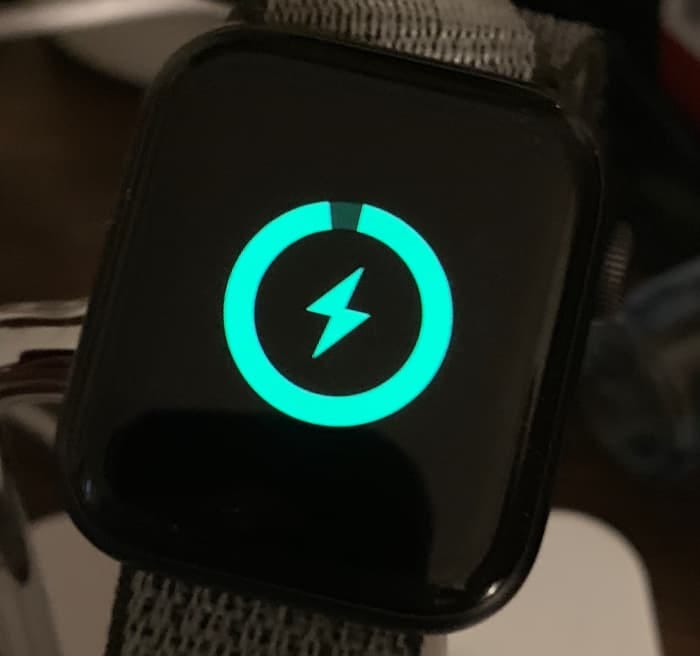 An almost fully charged Apple Watch on its charger