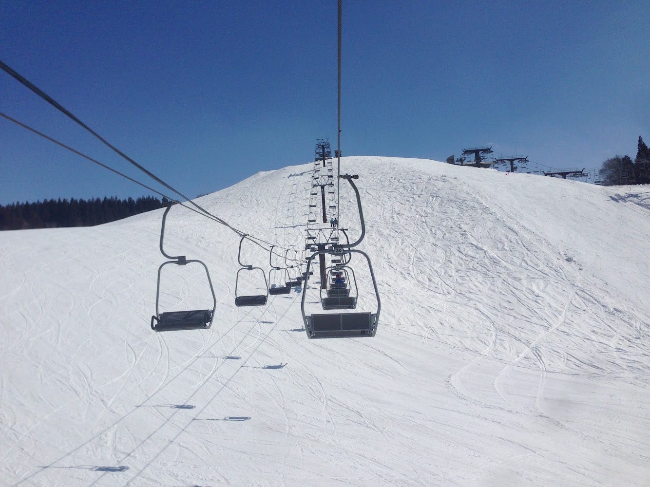 Photo on the Yudonosan Ski Field lift reaching the top of a snowy hill