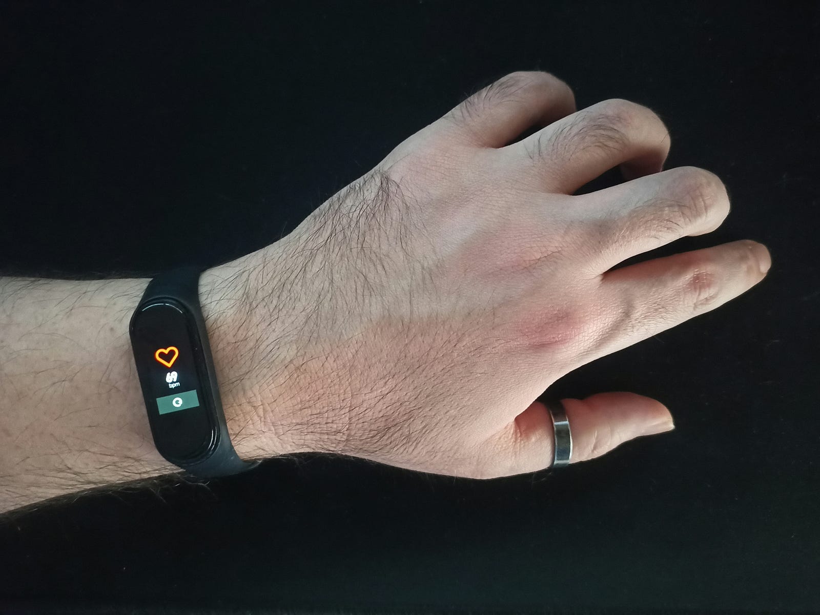 A wrist device (Fitbit) measuring a person’s pulse (heart rate).