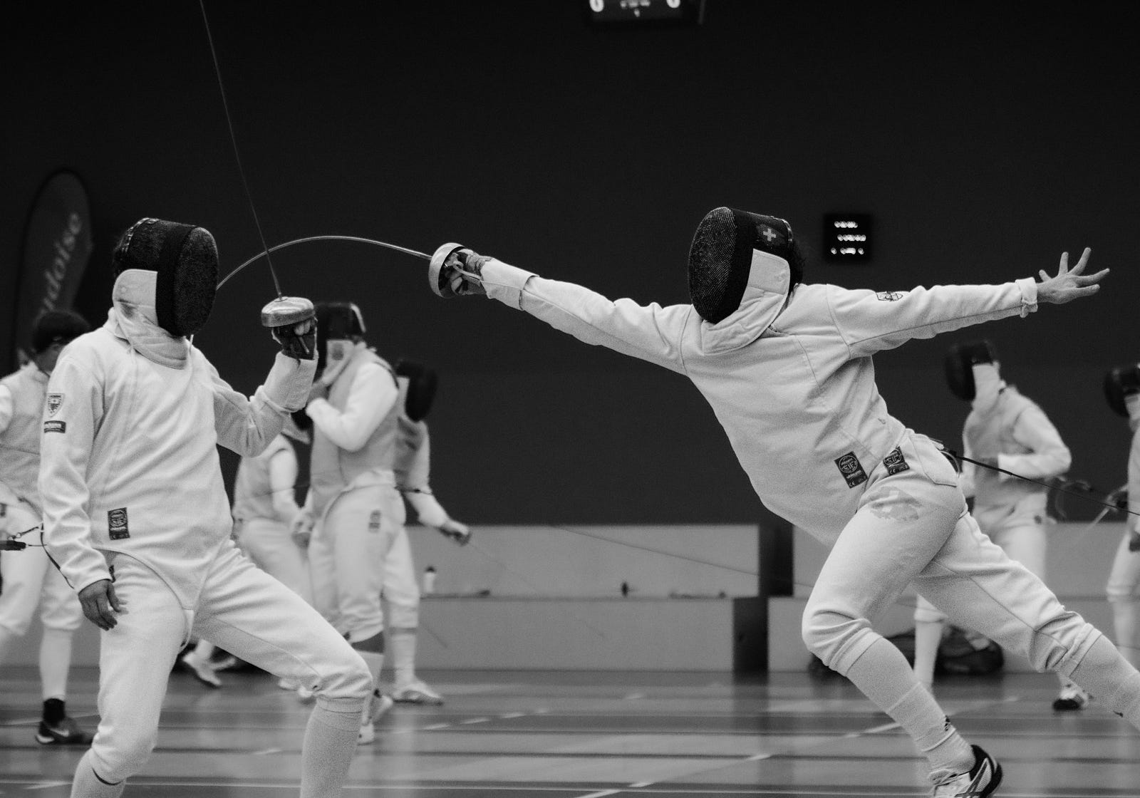 Foil fencers compete. Low-intensity exercise primarily relies on the aerobic energy system, which trains the body to efficiently utilize fat as a fuel source.