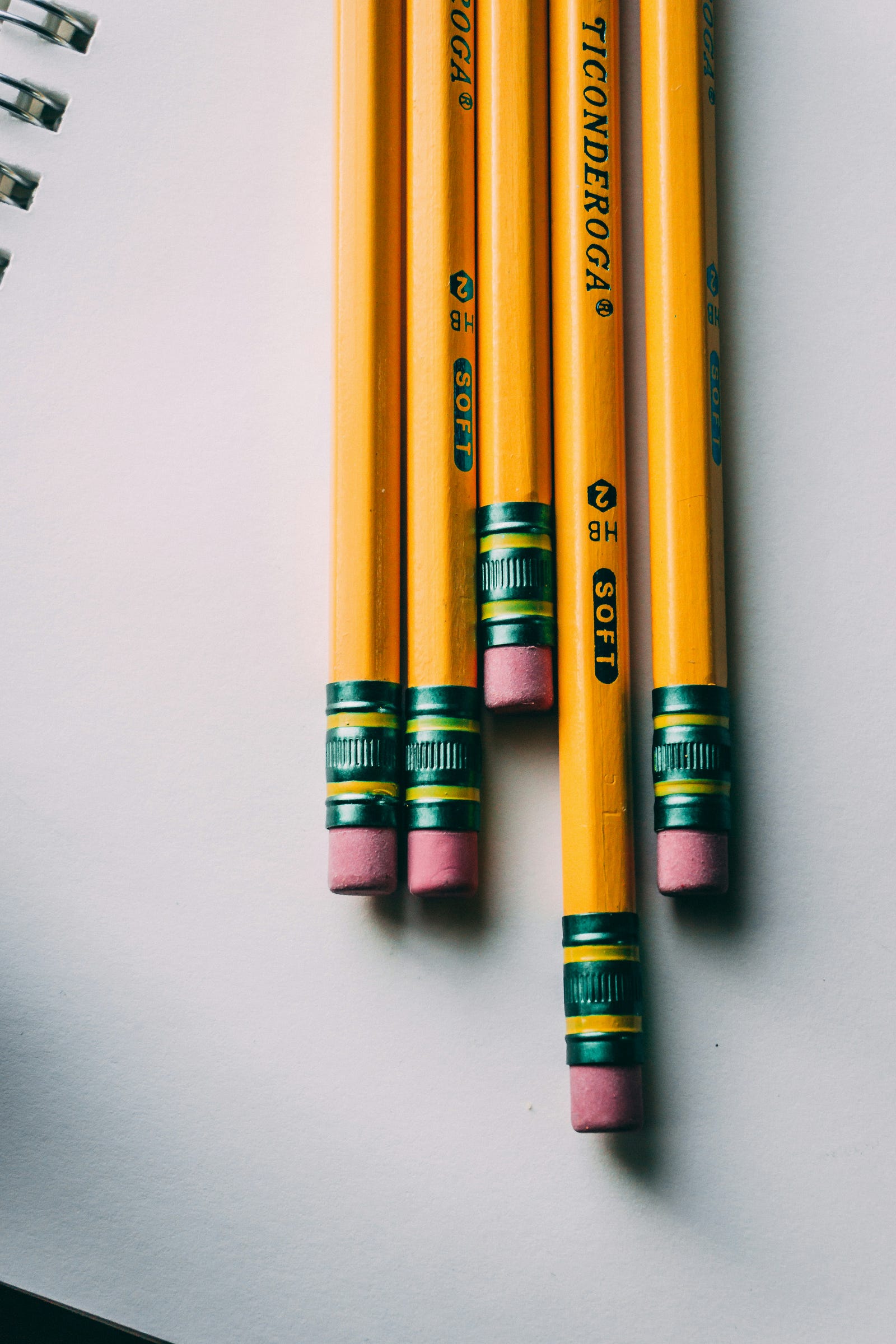 Five pencils, vertically aligned.