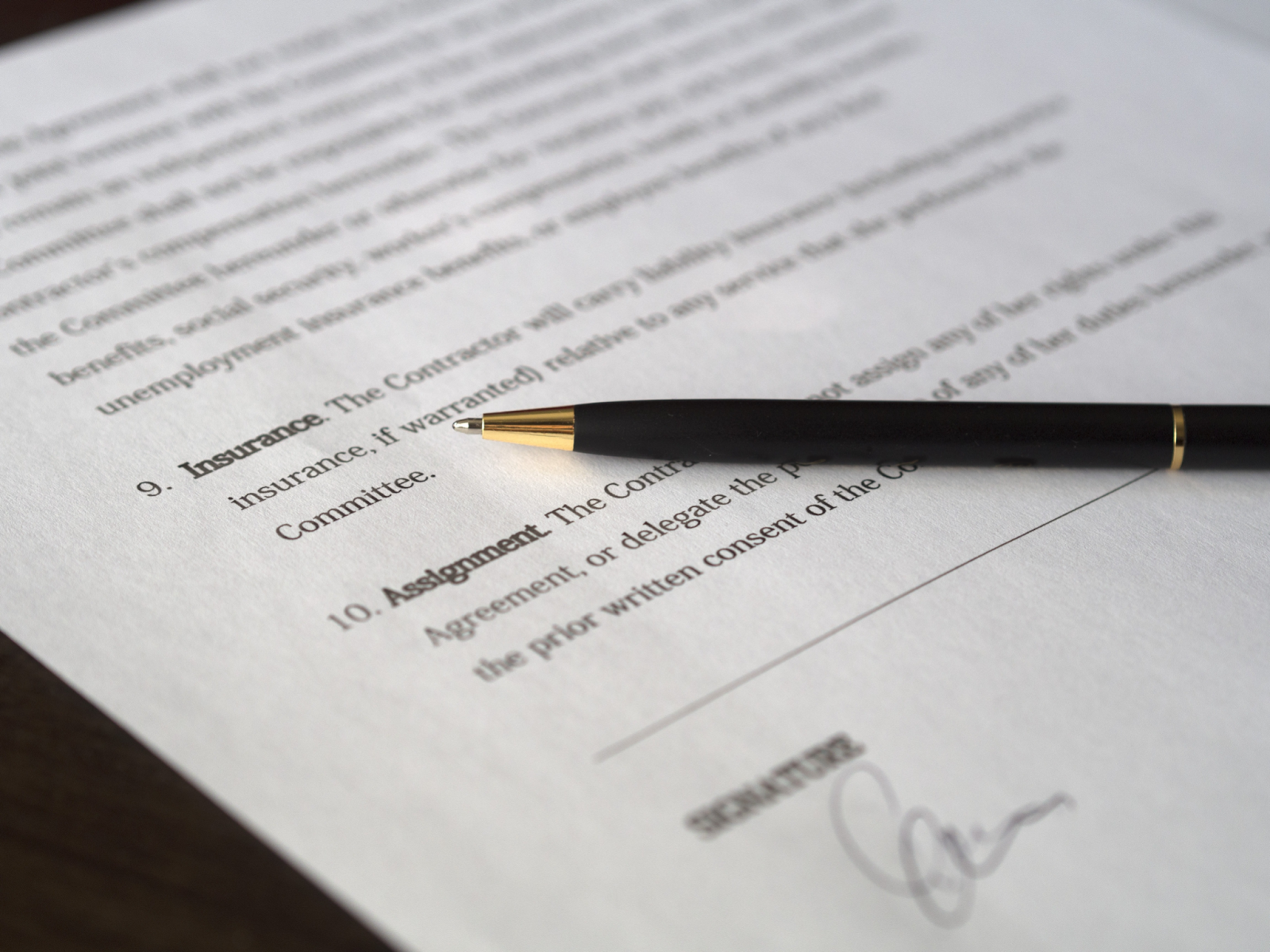 contract documentation with pen on top of paper