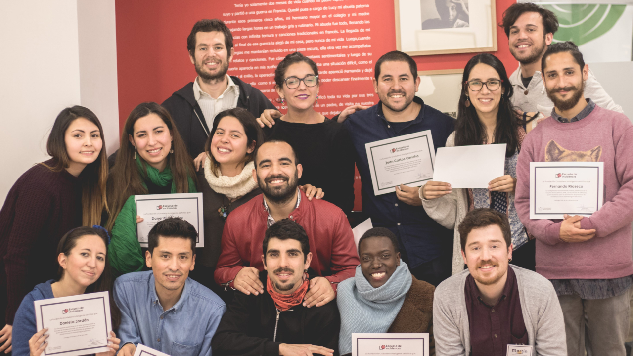Several people posing for a group photo while holding up certificates.