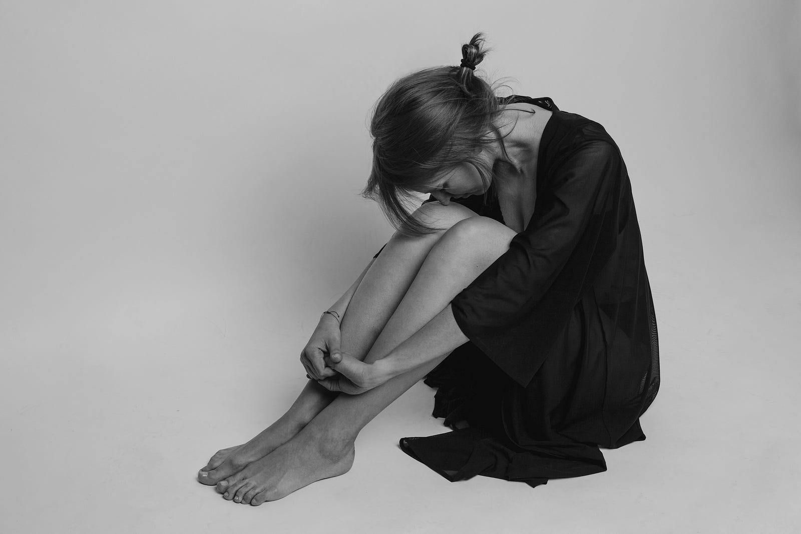 A young woman sits on the floor, legs together and her head bent down to her legs. Major depression affects individuals from all walks of life, irrespective of age, gender, socioeconomic status, or cultural background. It is not limited to a specific demographic group and can occur in children, adolescents, adults, and older adults.