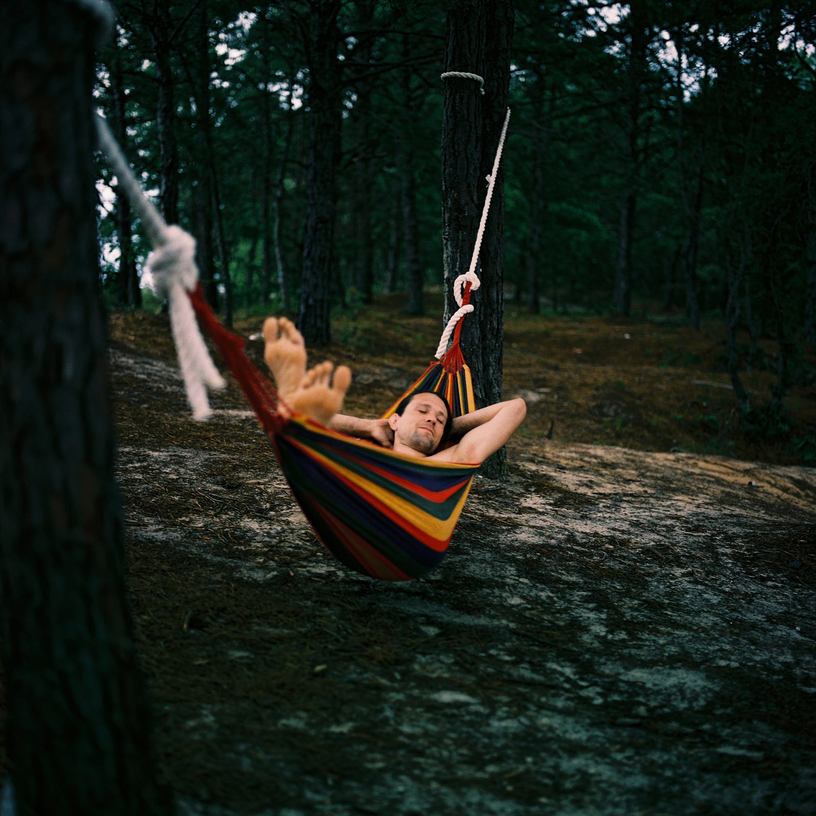A young man sleeps in a hammock. Power naps help me improve: Alertness, concentration, focus, mood, and short-term memory.