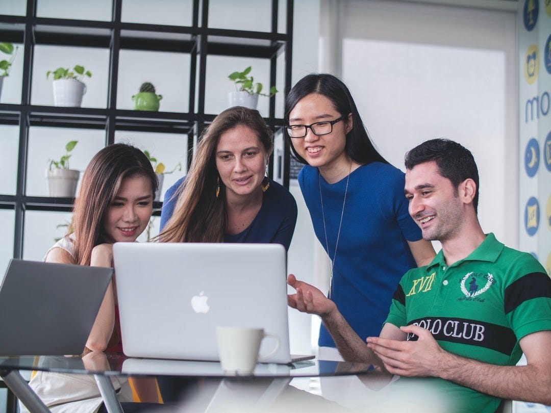 happy employees discussing with each other