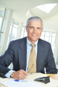 Businessman seated at desk in office setting
