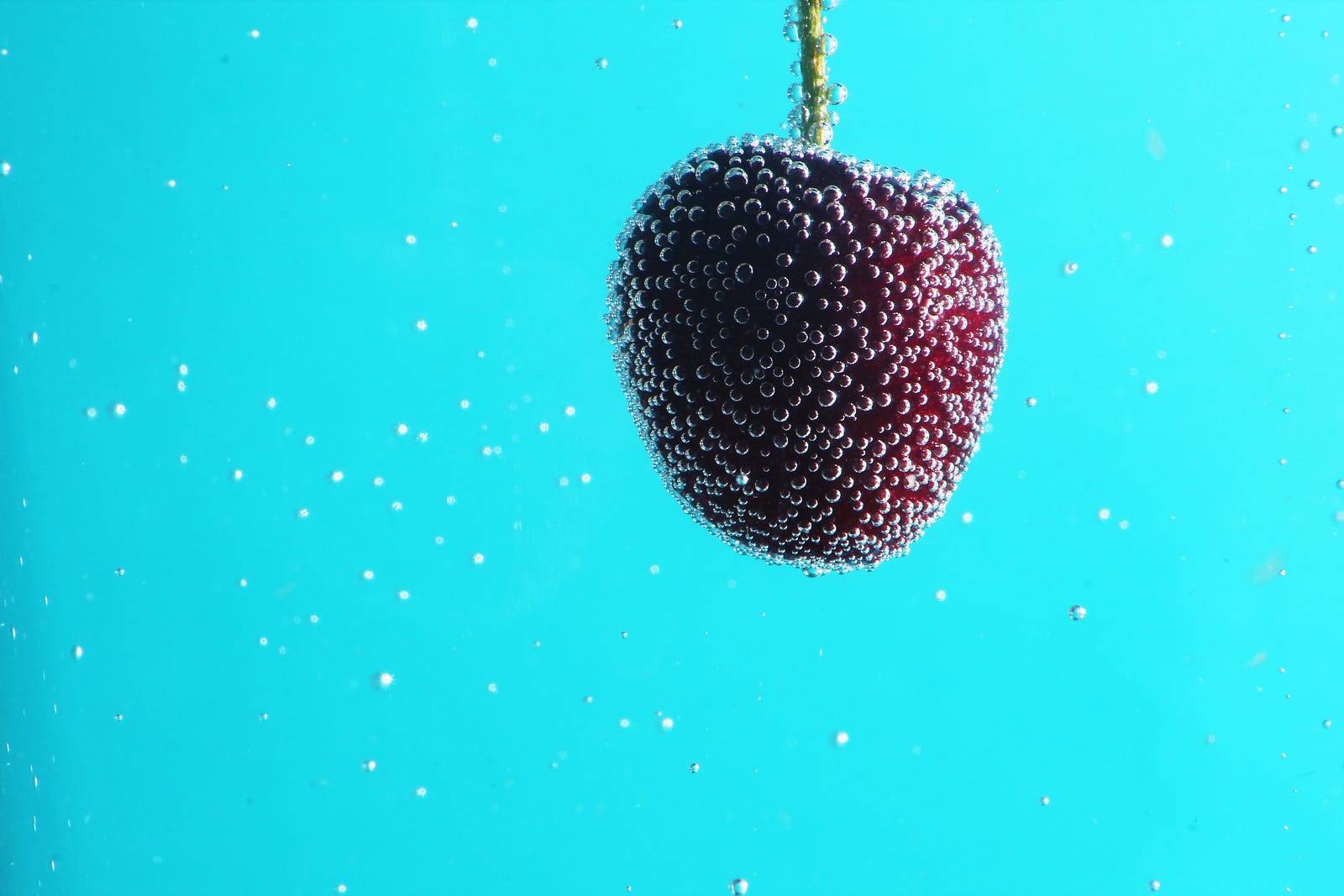 A cherry floats in sparkling water, with a powder blue background. In conclusion, sparkling water offers several potential health benefits that can make it an appealing choice for those looking to maintain or improve their well-being. It can contribute to hydration, aid digestion for some individuals, and be a tooth-friendly alternative to sugary beverages.