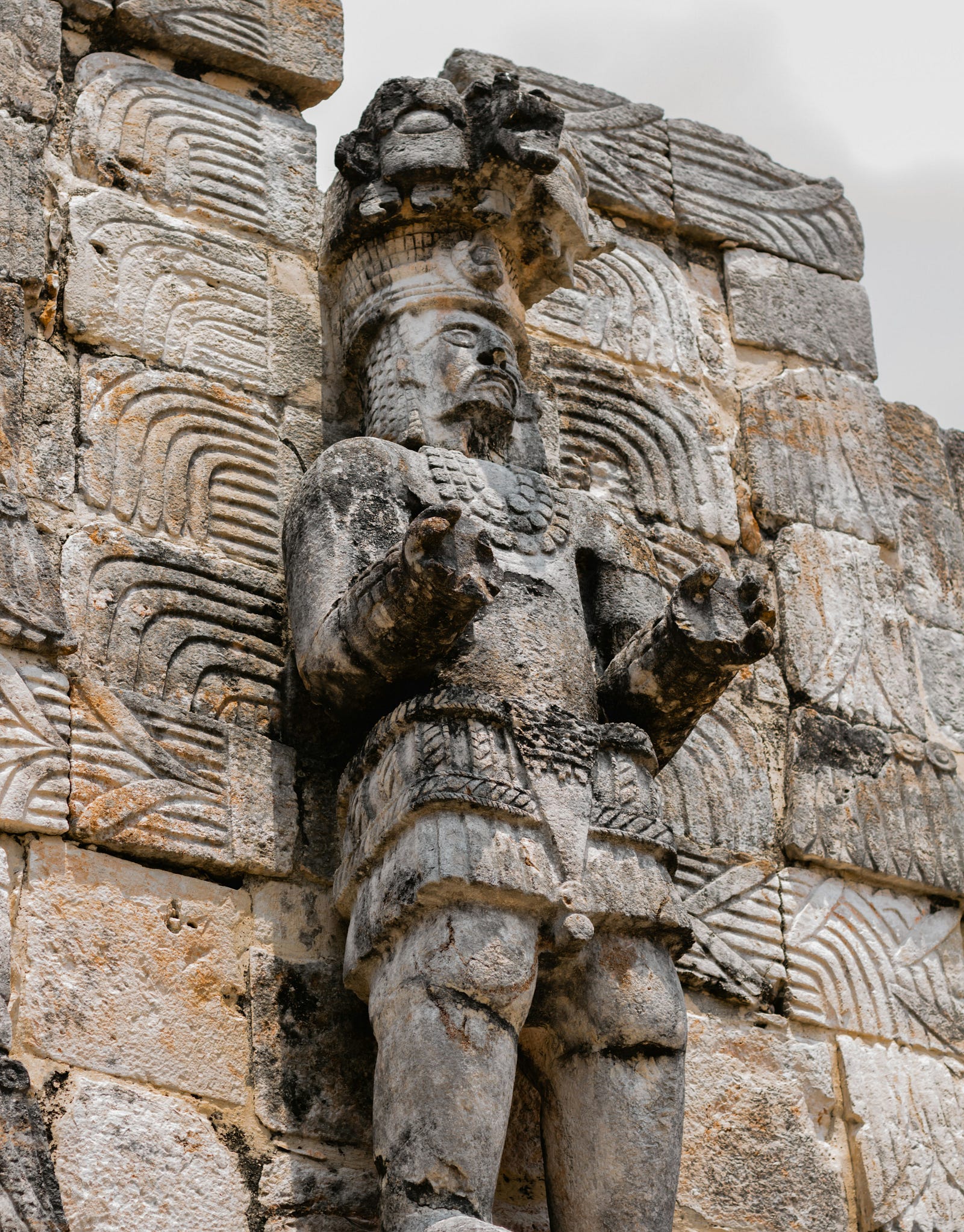 A Mayan statue of a male figure perches on the outside of an ancient building. These ancients used chicle (a natural tree gum) as a base to make a gum-like material chicle and to stick objects together in everyday use.