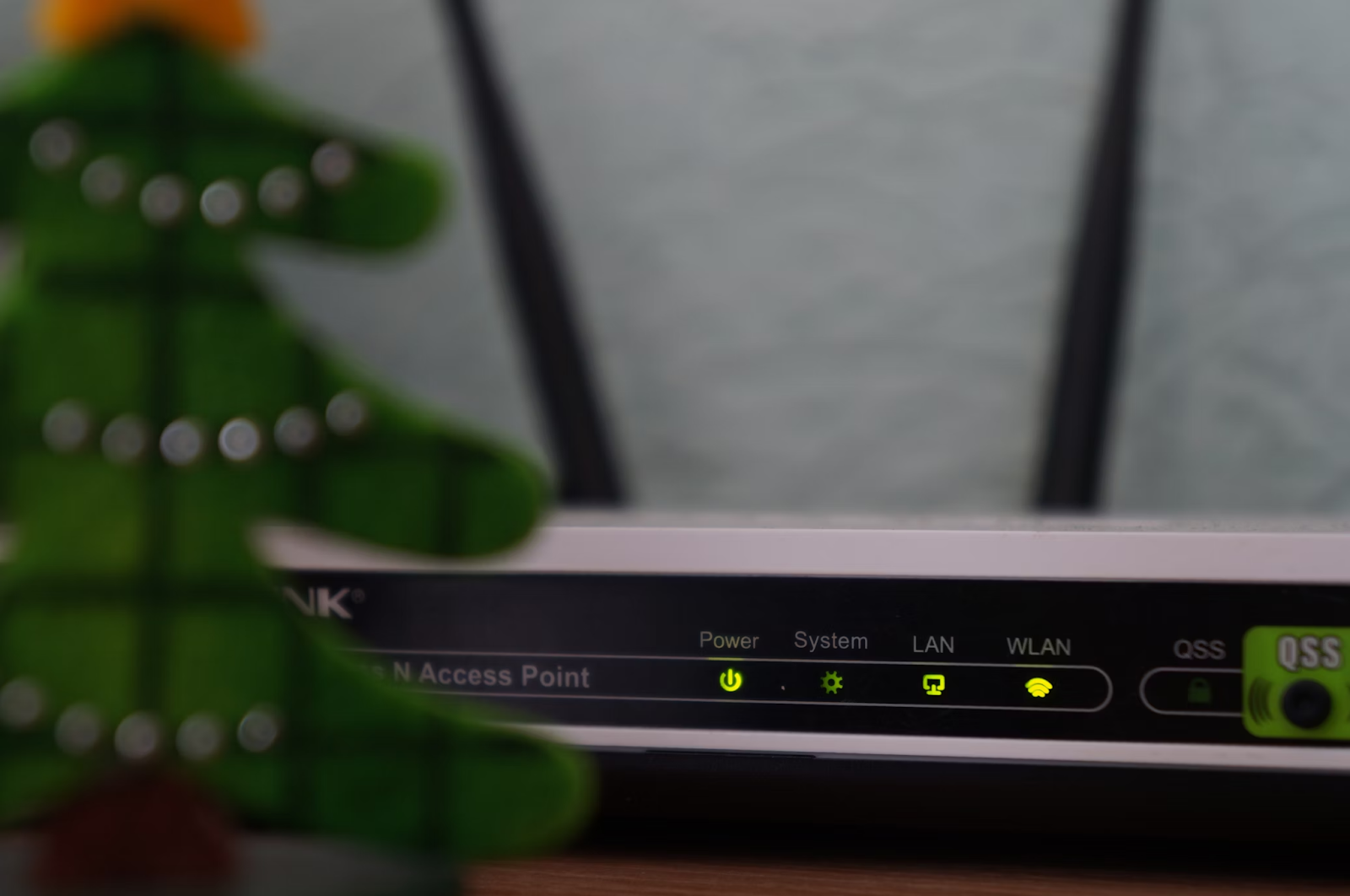 A modem-router with a white and black design, featuring four indicator lights