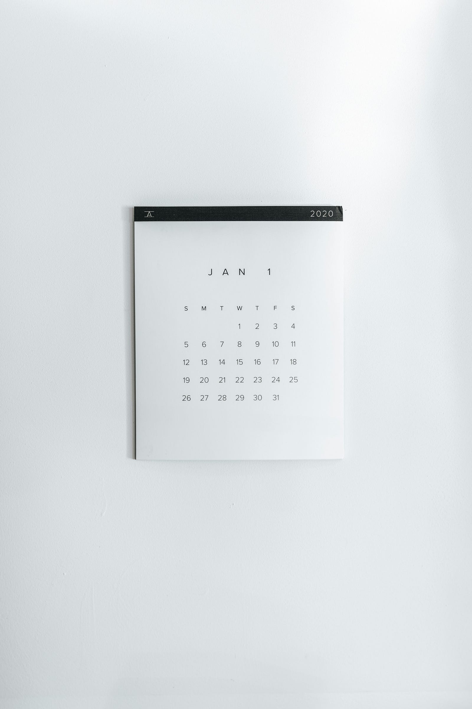 A simple white calendar with black letters hands on a wall. Patients with cancer who have vaccination gaps would ideally receive their vaccinations two to four weeks before cancer treatment begins; however, non-live vaccines can be given during or after treatment.