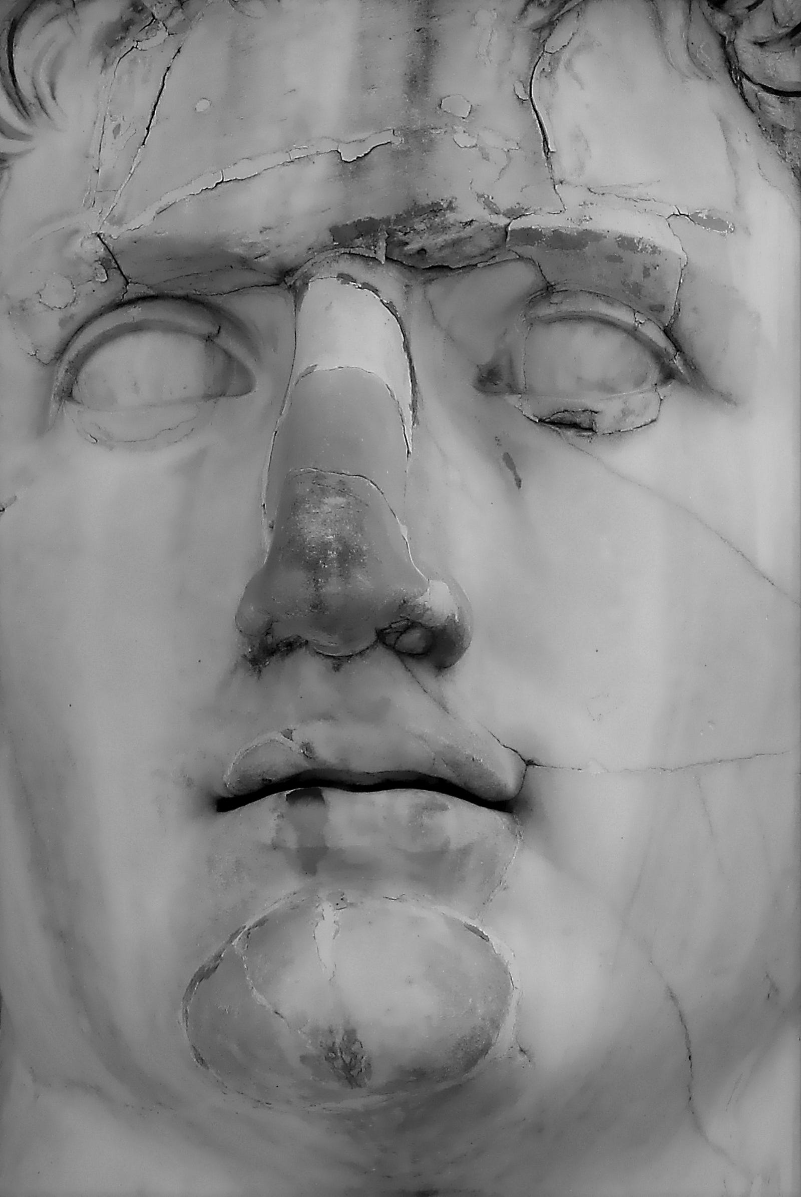 An ancient sculpture with a cracked nose.