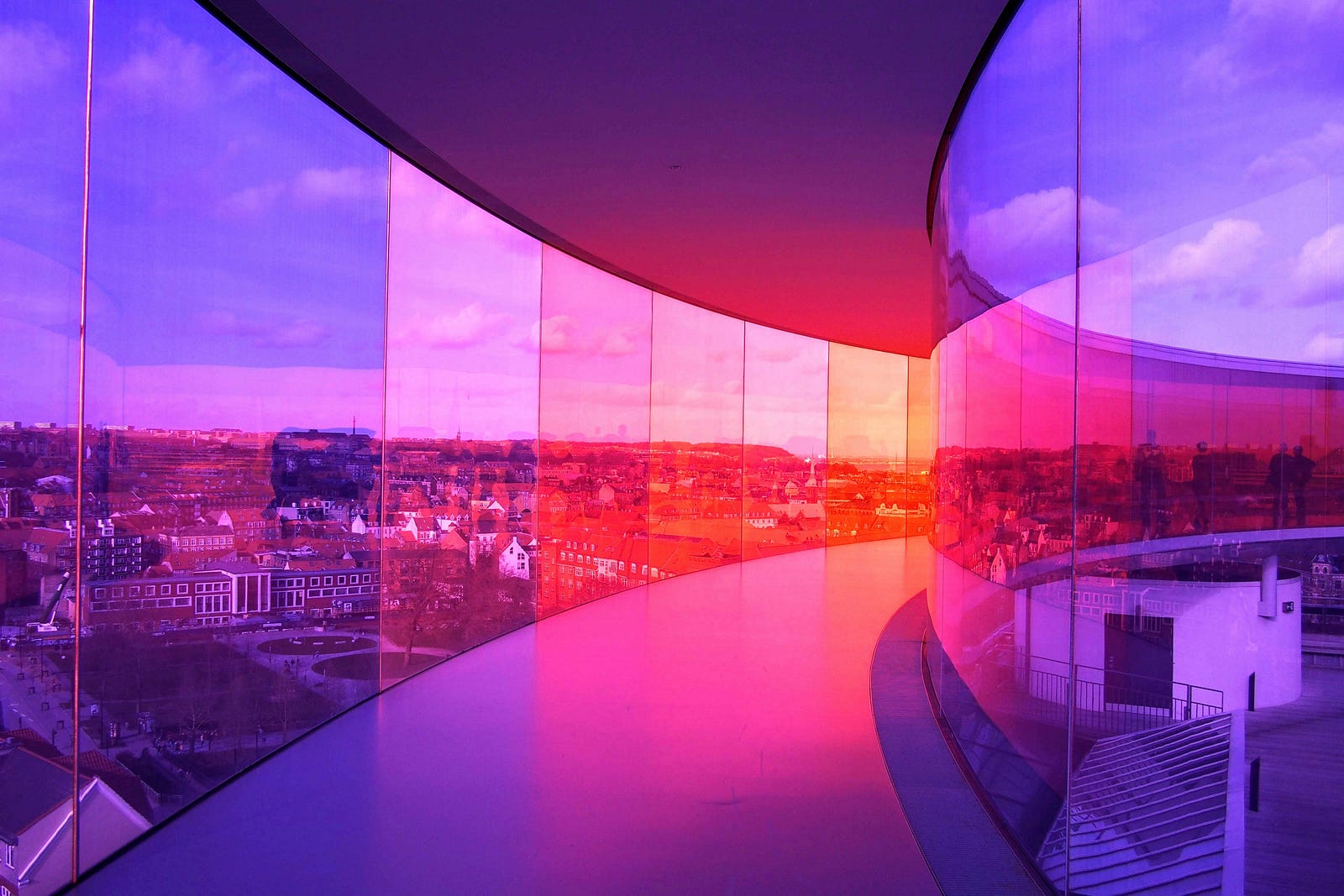 Sunset, as scene from a building in Copenhagen. The windows extend floor to ceiling in this curved structure.