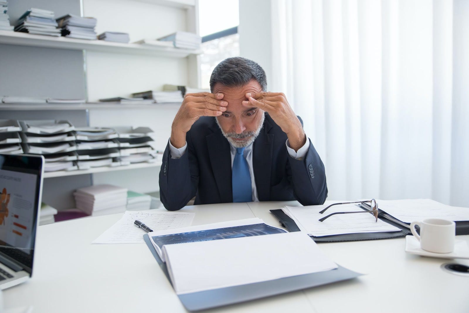 man stressed while looking at documents