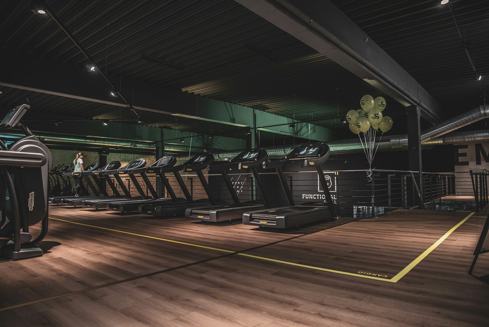 Treadmills in a relatively dark gym.