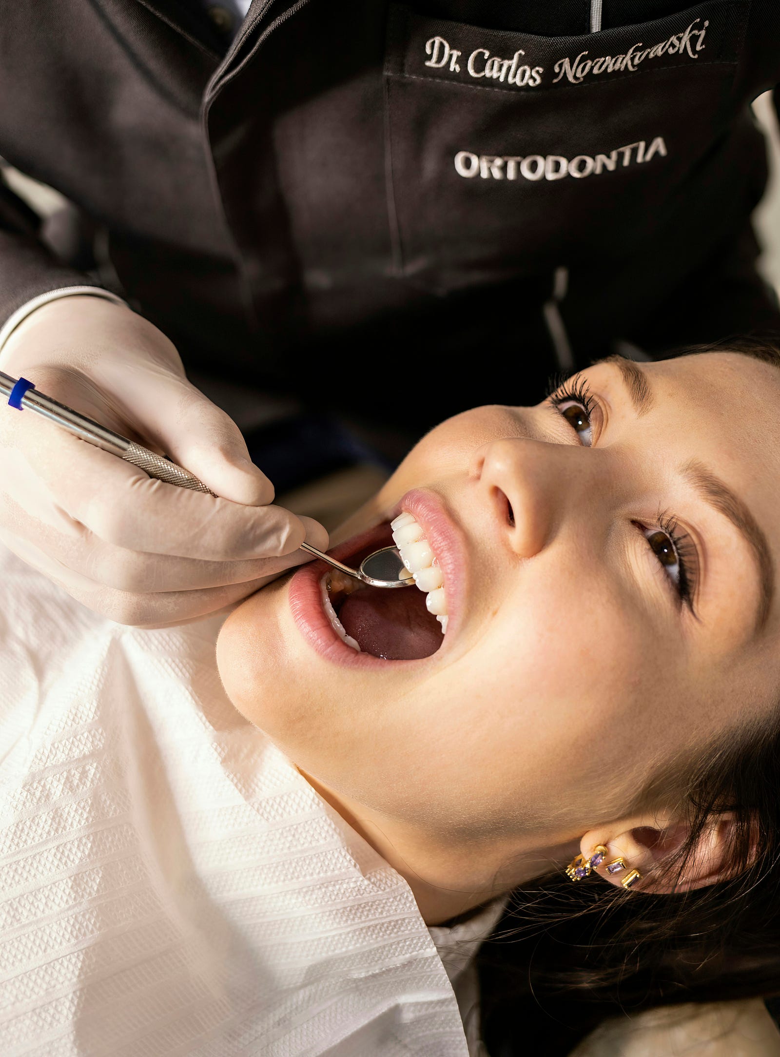 A dentist examines a woman’s mouth for oral cancer. A new study suggests an association between marijuana use and head and neck cancer.