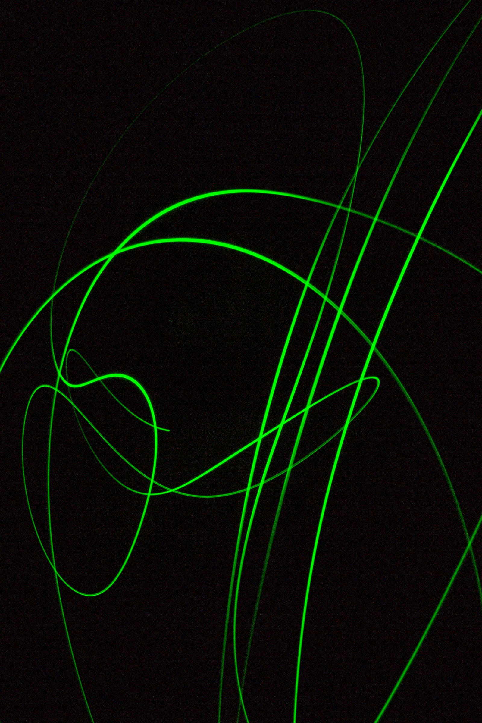 Green ribbons of laser-like light. The Blueprint anti-aging program incorporates laser and red light therapy.